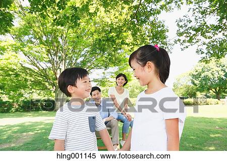 Stock Photography - Happy Japanese family in a city park. Fotosearch