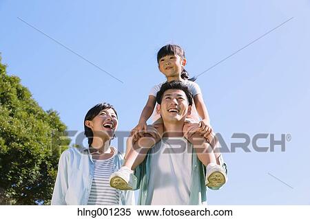 Stock Photography - Happy Japanese family in a city park. Fotosearch