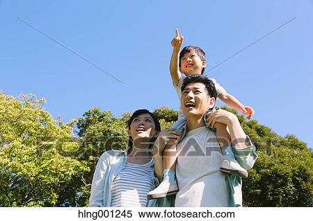Stock Photography - Happy Japanese family in a city park. Fotosearch