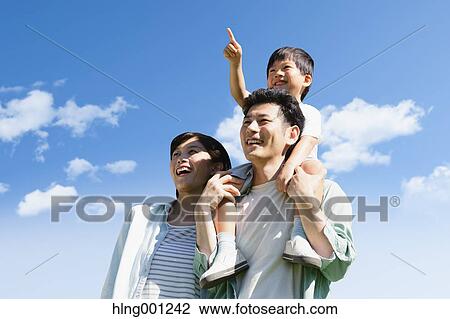 Stock Image - Happy Japanese family smiling. Fotosearch