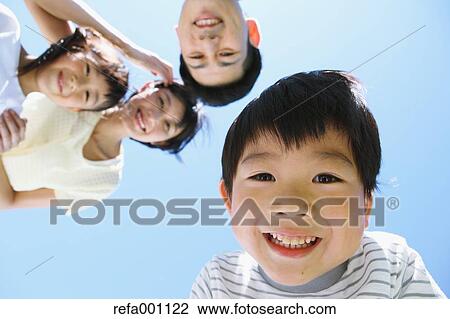 Stock Image - Happy Japanese family smiling. Fotosearch