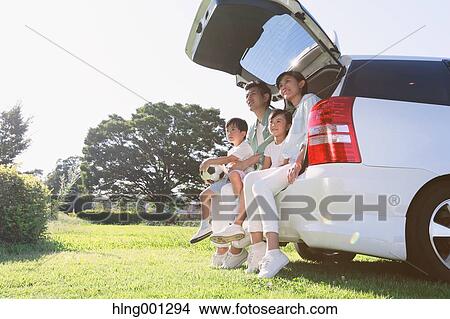Happy Japanese family with car in a city park View Large Photo Image Picture - Happy Japanese family with car in a city park. Fotosearch