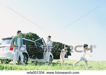 Happy Japanese family with car in a city park View Large Photo Image Picture - Happy Japanese family with car in a city park. Fotosearch