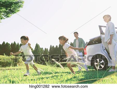 Happy Japanese family with car in a city park View Large Photo Image Stock Image - Happy Japanese family with car in a city park. Fotosearch