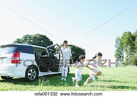 Happy Japanese family with car in a city park View Large Photo Image Stock Image - Happy Japanese family with car in a city park. Fotosearch
