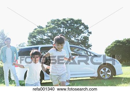 Happy Japanese family with car in a city park View Large Photo Image Stock Image - Happy Japanese family with car in a city park. Fotosearch