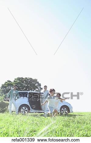 Happy Japanese family with car in a city park View Large Photo Image Stock Photo - Happy Japanese family with car in a city park. Fotosearch