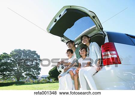 Happy Japanese family with car in a city park View Large Photo Image Stock Photo - Happy Japanese family with car in a city park. Fotosearch