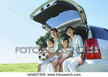 Happy Japanese family with car in a city park View Large Photo Image Stock Photo - Happy Japanese family with car in a city park. Fotosearch