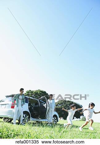 Happy Japanese family with car in a city park View Large Photo Image Stock Photography - Happy Japanese family with car in a city park. Fotosearch