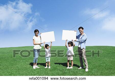 Happy Japanese family with whiteboards in a city park View Large Photo Image Picture - Happy Japanese family with whiteboards in a city park. Fotosearch