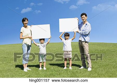 Happy Japanese family with whiteboards in a city park View Large Photo Image Stock Photo - Happy Japanese family with whiteboards in a city park. Fotosearch