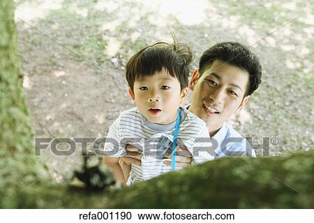 Happy Japanese father and son catching insects in a city park View Large Photo Image Stock Image - Happy Japanese father and son catching insects in a city park. Fotosearch