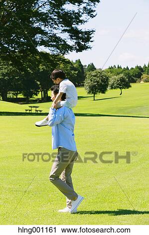 Happy Japanese father and son in a city park View Large Photo Image Stock Image - Happy Japanese father and son in a city park. Fotosearch