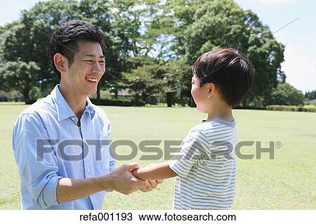 Happy Japanese father and son in a city park View Large Photo Image Stock Image - Happy Japanese father and son in a city park. Fotosearch