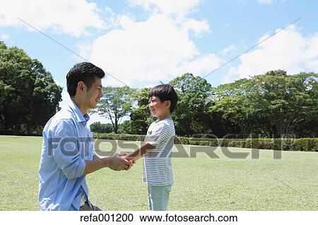Happy Japanese father and son in a city park View Large Photo Image Stock Image - Happy Japanese father and son in a city park. Fotosearch