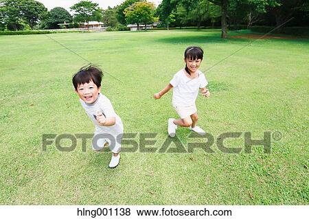 Stock Photo - Happy Japanese kids in a city park. Fotosearch