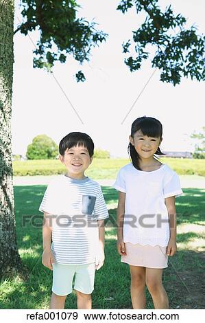 Stock Photo - Happy Japanese kids in a city park. Fotosearch