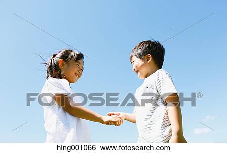 Stock Photograph - Happy Japanese kids in a city park. Fotosearch