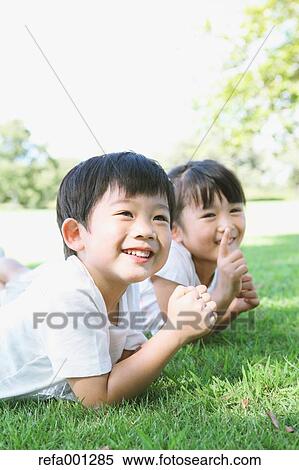 Stock Photography - Happy Japanese kids in a city park. Fotosearch