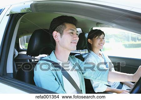 Japanese couple riding a car in nature View Large Photo Image Picture - Japanese couple riding a car in nature. Fotosearch