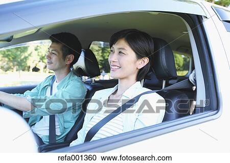 Japanese couple riding a car in nature View Large Photo Image Stock Image - Japanese couple riding a car in nature. Fotosearch