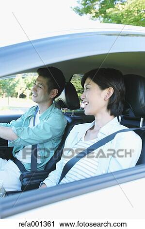 Japanese couple riding a car in nature View Large Photo Image Stock Image - Japanese couple riding a car in nature. Fotosearch