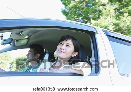 Japanese couple riding a car in nature View Large Photo Image Stock Photo - Japanese couple riding a car in nature. Fotosearch