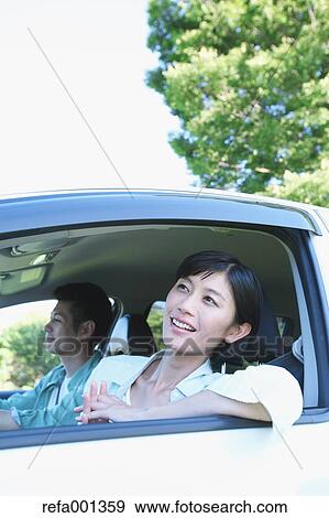 Japanese couple riding a car in nature View Large Photo Image Stock Photo - Japanese couple riding a car in nature. Fotosearch