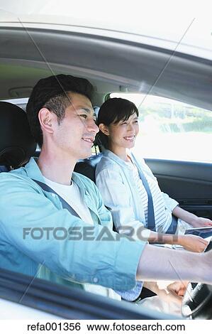 Japanese couple riding a car in nature View Large Photo Image Stock Photograph - Japanese couple riding a car in nature. Fotosearch