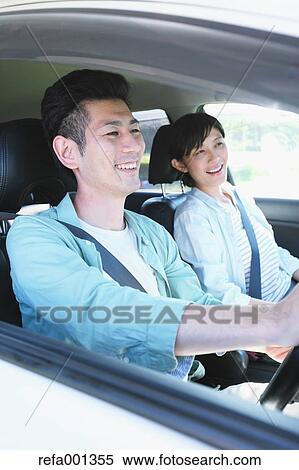 Japanese couple riding a car in nature View Large Photo Image Stock Photography - Japanese couple riding a car in nature. Fotosearch