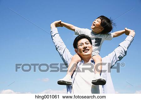 Stock Image - Japanese father and son laughing. Fotosearch
