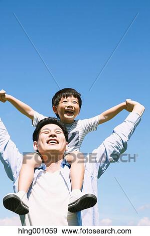 Stock Photo - Japanese father and son laughing. Fotosearch