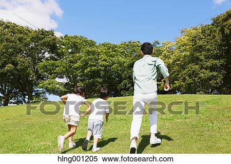 Japanese father playing with his kids in a city park View Large Photo Image Stock Photography - Japanese father playing with his kids in a city park. Fotosearch