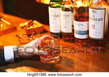 Japanese man with glass of whiskey in a fashionable bar View Large Photo Image Stock Photo - Japanese man with glass of whiskey in a fashionable bar. Fotosearch