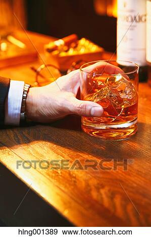 Japanese man with glass of whiskey in a fashionable bar View Large Photo Image Stock Photo - Japanese man with glass of whiskey in a fashionable bar. Fotosearch