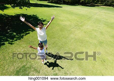 Picture - Japanese mother and daughter in a city park. Fotosearch