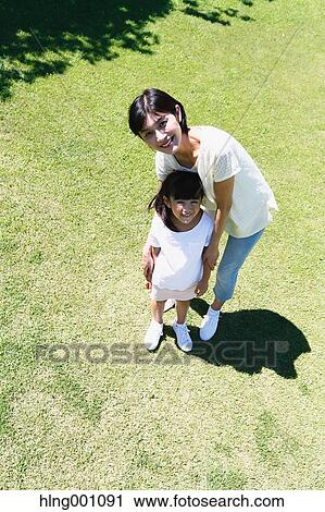 Japanese mother and daughter in a city park View Large Photo Image Stock Image - Japanese mother and daughter in a city park. Fotosearch
