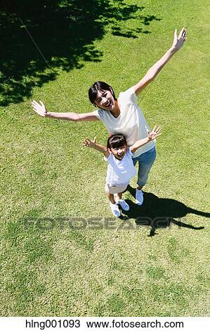 Japanese mother and daughter in a city park View Large Photo Image Stock Image - Japanese mother and daughter in a city park. Fotosearch