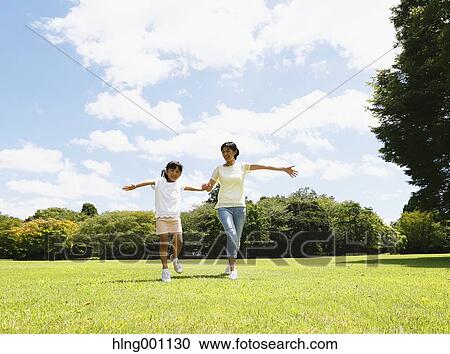 Japanese mother and daughter in a city park View Large Photo Image Stock Image - Japanese mother and daughter in a city park. Fotosearch