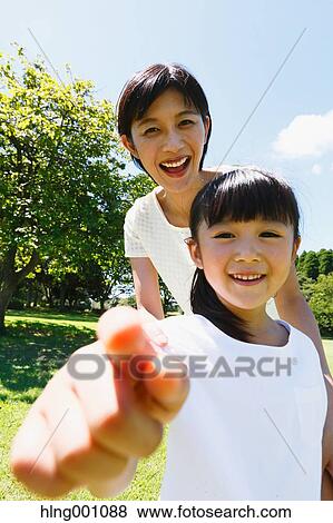 Japanese mother and daughter in a city park View Large Photo Image Stock Photo - Japanese mother and daughter in a city park. Fotosearch