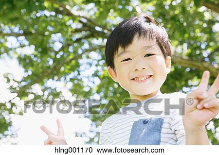 Japanese young boy in a city park View Large Photo Image Stock Image - Japanese young boy in a city park. Fotosearch