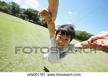 Stock Image - Japanese young boy in a city park. Fotosearch