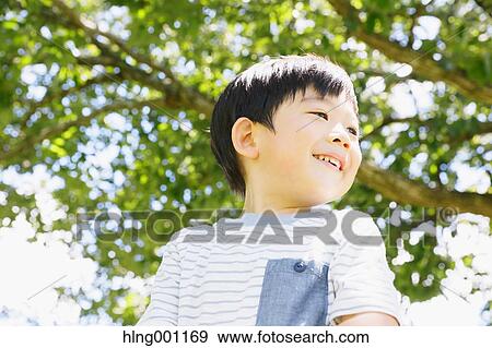 Japanese young boy in a city park View Large Photo Image Stock Photo - Japanese young boy in a city park. Fotosearch