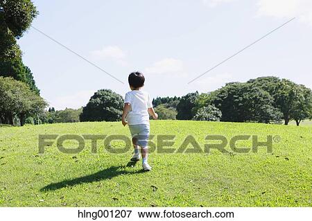 Japanese young boy in a city park View Large Photo Image Stock Photo - Japanese young boy in a city park. Fotosearch