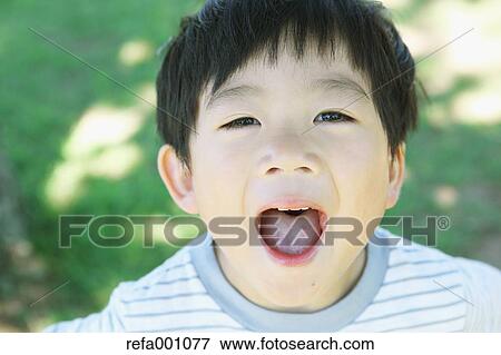 Stock Photo - Japanese young boy in a city park. Fotosearch