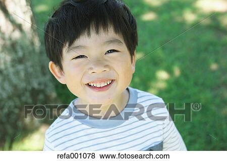 Japanese young boy in a city park View Large Photo Image Stock Photo - Japanese young boy in a city park. Fotosearch