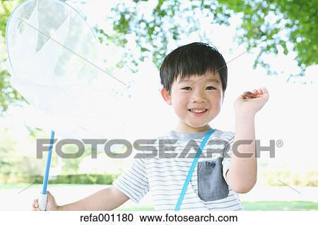 Japanese young boy with butterfly net in a city park View Large Photo Image Stock Image - Japanese young boy with butterfly net in a city park. Fotosearch