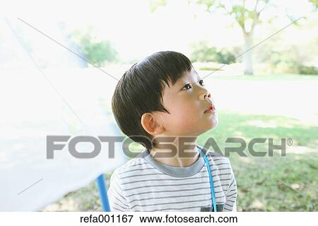Japanese young boy with butterfly net in a city park View Large Photo Image Stock Photo - Japanese young boy with butterfly net in a city park. Fotosearch