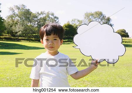 Japanese young boy with whiteboard in a city park View Large Photo Image Picture - Japanese young boy with whiteboard in a city park. Fotosearch